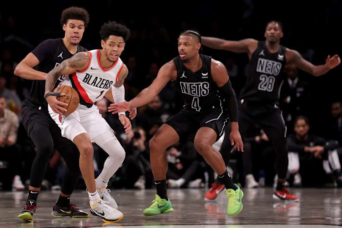 Portland Trail Blazers guard Anfernee Simons (1) controls the ball against Brooklyn Nets forward Cameron Johnson (2) and guard Dennis Smith Jr. (4) and forward Dorian Finney-Smith (28)